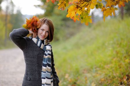 Young beautiful autumn lady in the parkの写真素材