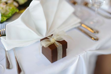 Table set for a festive party or dinner with a brown boxの写真素材