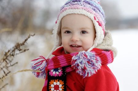 Little winter baby girl in red coatの写真素材