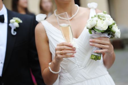 Bride is holding a glass of champagneの写真素材