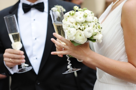 Bride and groom are holding champagne glassesの写真素材