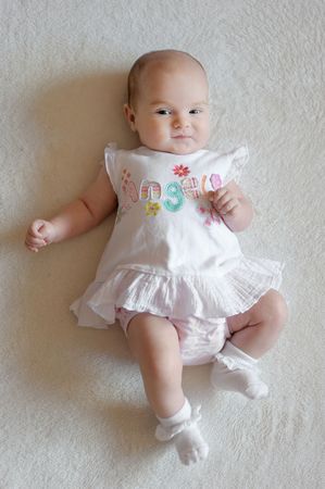 Two month old baby girl in a white dressの写真素材