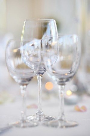 Three wine glasses on a white festive tableの写真素材