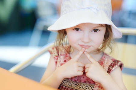 Adorable happy little girl smiling outdoorsの写真素材