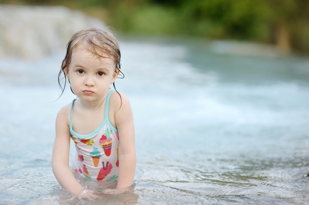Adorable child in swimming suit on a beachの写真素材