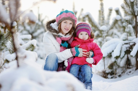 Young mother and her daughter at winter dayの写真素材