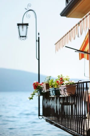 Flowers hanging on a balcony by Garda lakeの写真素材