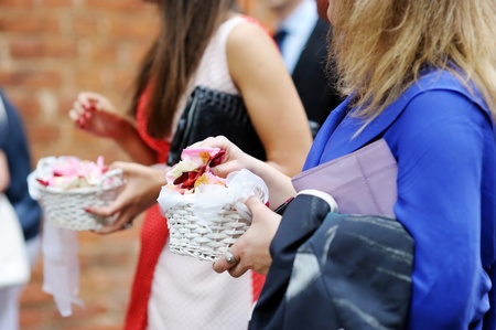 Women hang holding rose petals ready to throw