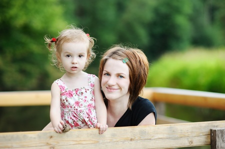 Young mother holding her adorable toddler girlの写真素材