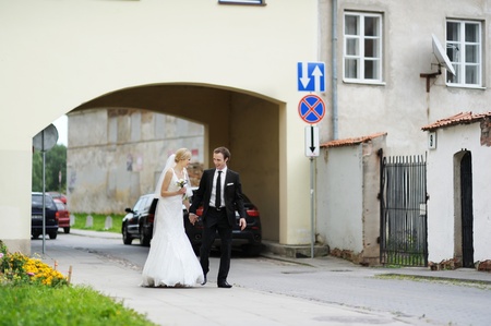 Bride and groom having fun in an old townの写真素材