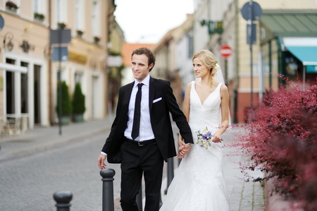 Bride and groom having fun in an old townの写真素材