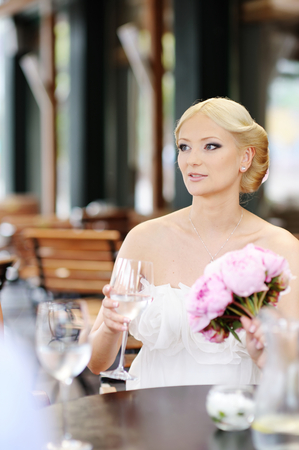 Bride drinking champagne at her weddingの写真素材
