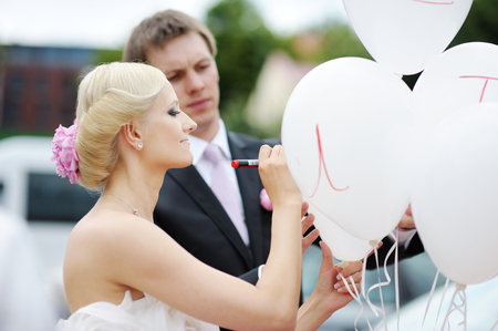 Bride and groom writing on a balloonの写真素材