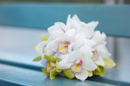 Beautiful white wedding florals on a blue benchの写真素材