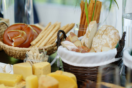 Cheese and bread assortment on a tableの写真素材
