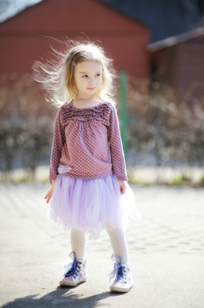 Adorable girl having fun on early springの写真素材
