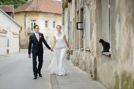 Happy bride and groom taking a walk togetherの写真素材