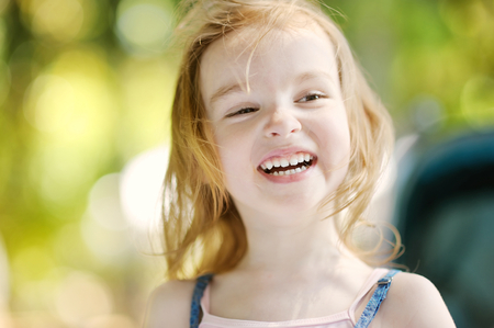 Adorable little girl portrait outdoors at summerの写真素材
