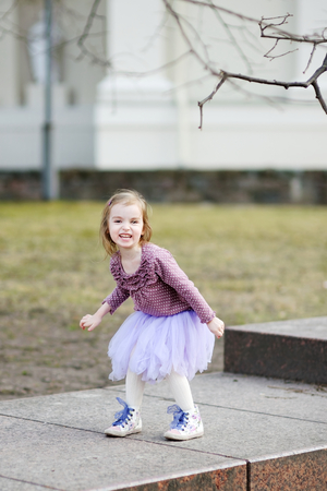 Adorable girl having fun on early springの写真素材