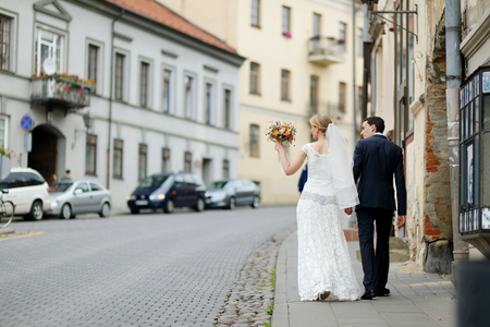 Happy bride and groom walking togetherの写真素材