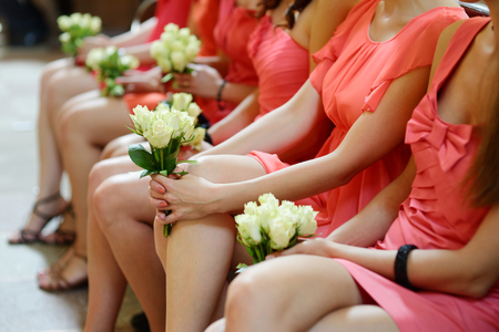 Row of bridesmaids with bouquets at wedding ceremonyの写真素材