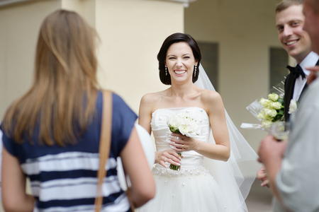 Wedding guests toasting happy bride and groomの写真素材