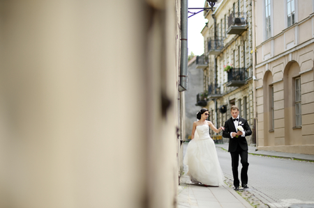 Happy bride and groom walking togetherの写真素材