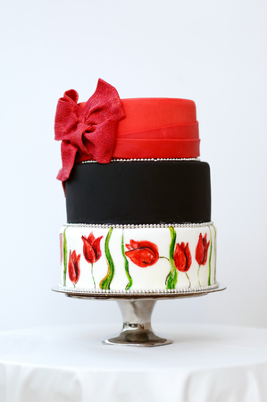 Three stories wedding cake decorated with colorful flowersの写真素材