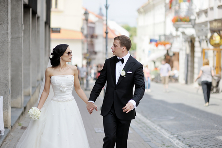 Happy bride and groom walking togetherの写真素材