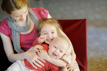 Young mother and her two little daughtersの写真素材