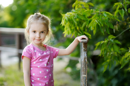 Adorable little girl portrait outdoors at summerの写真素材