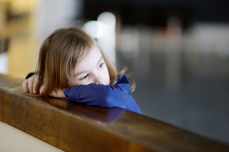 Thoughtful little girl portrait indoorsの写真素材