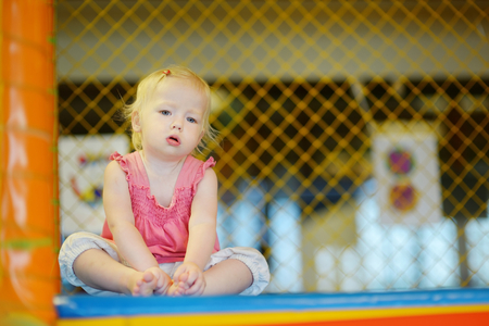 Little toddler girl having fun at the playgroundの写真素材