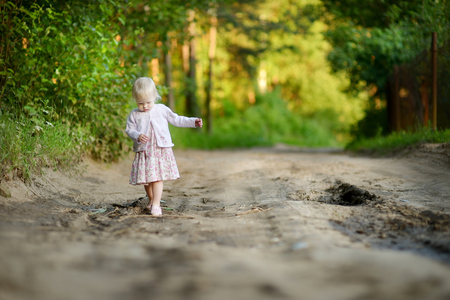Toddler girl having a walk in the woodsの写真素材