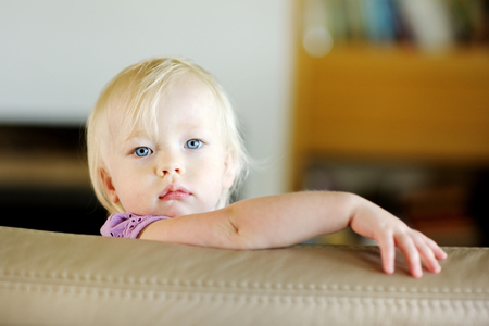 Adorable toddler girl portrait at homeの写真素材