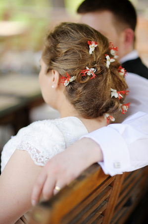 Bride and groom having fun at outdoor cafeの写真素材