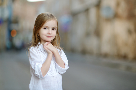 Adorable little girl portrait outdoors at summerの写真素材