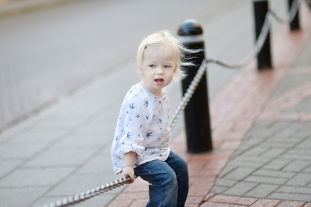 Adorable little girl portrait outdoors at summerの写真素材