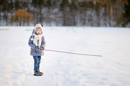 Adorable little girl having fun on winter dayの写真素材