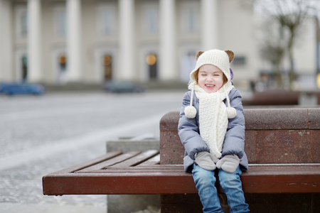 Adorable little girl having fun on winter dayの写真素材