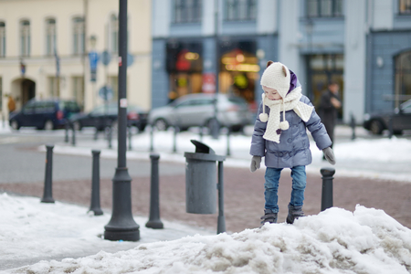 Adorable little girl having fun on winter dayの写真素材