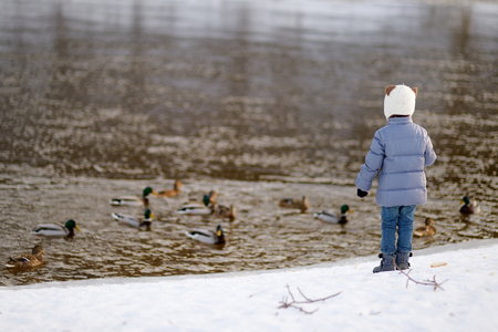 Adorable little girl having fun on winter dayの写真素材