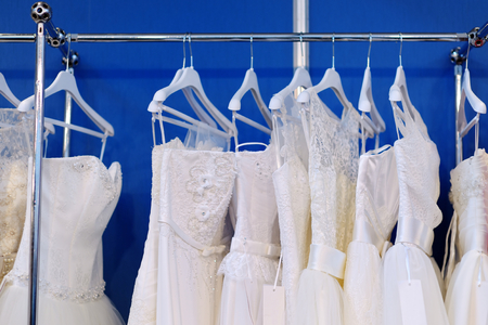 A few beautiful wedding dresses on a hangerの写真素材