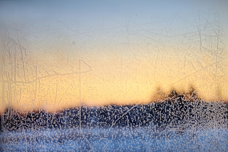 Beautiful ice pattern and sunlight on winter glassの写真素材