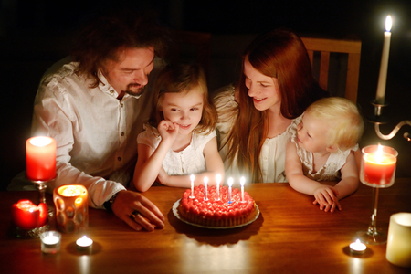 Happy family celebrating their daughter's fifth birthday