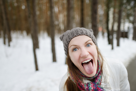 Young funny woman being silly on winterの写真素材