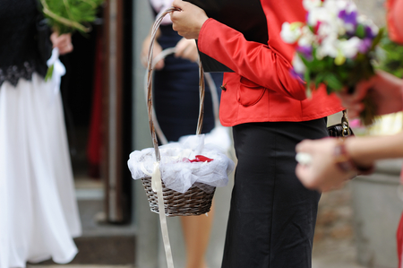 Woman holding flowers basket at the wedding