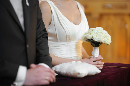 Bride holding beautiful white wedding flowers bouquetの写真素材