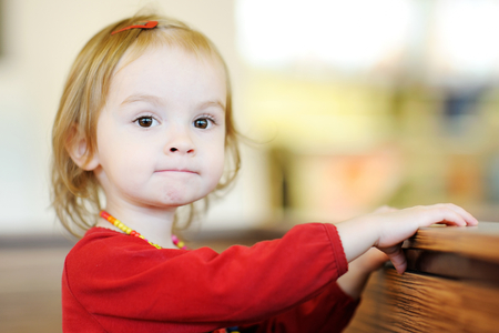 Funny little girl in red dressの写真素材