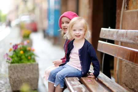 Portrait of two cute little sisters outdoorsの写真素材